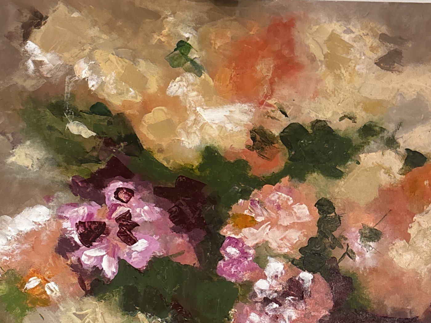 A floral painting taking shape in warm pinks, orange and green